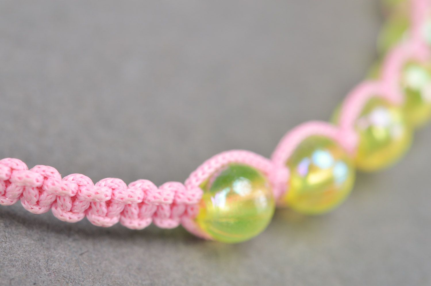 Beautiful stylish handmade children's bracelet woven of threads and beads of gentle pink color photo 4