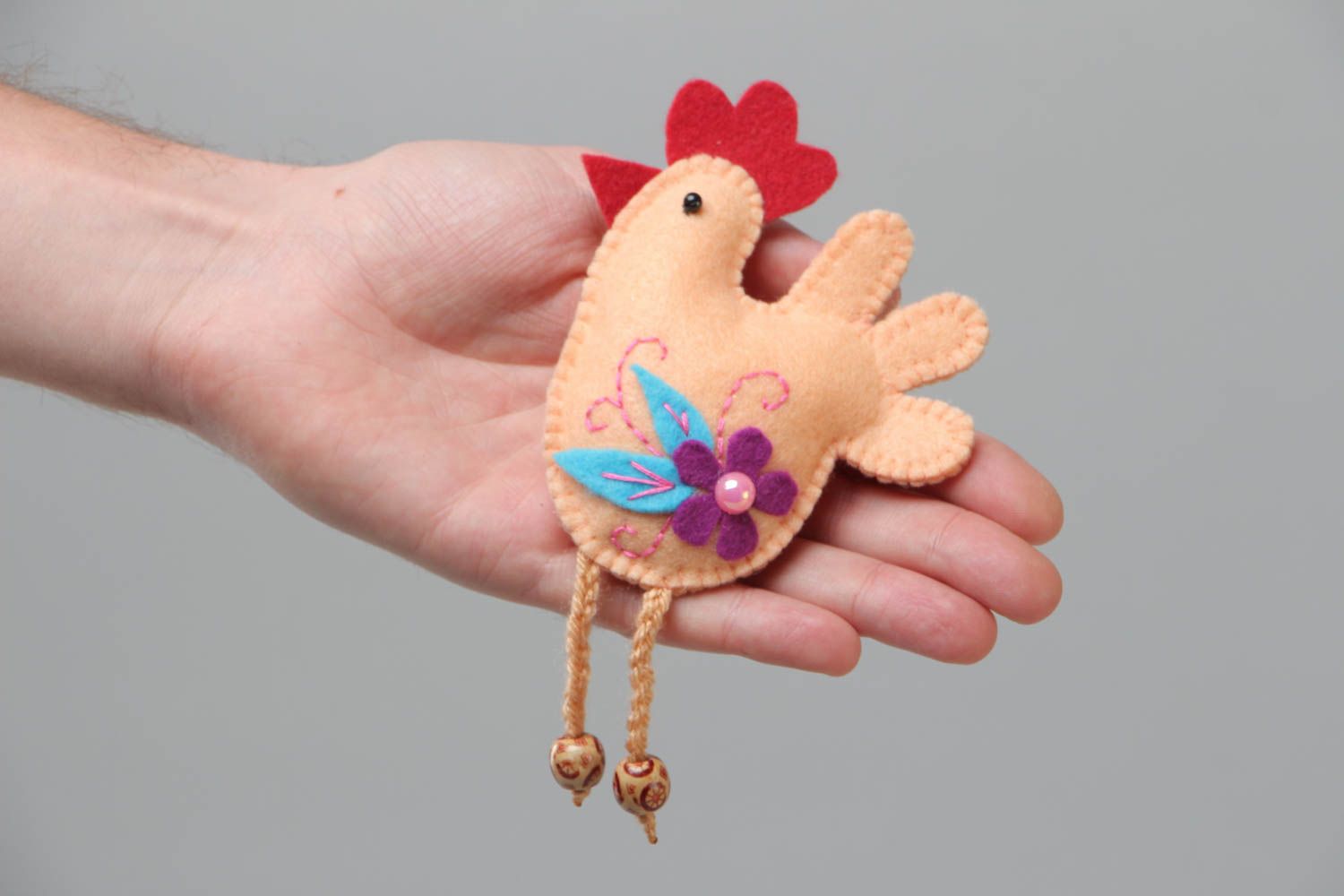 Handmade soft toy fridge magnet in the shape of felt cockerel with thread paws photo 5