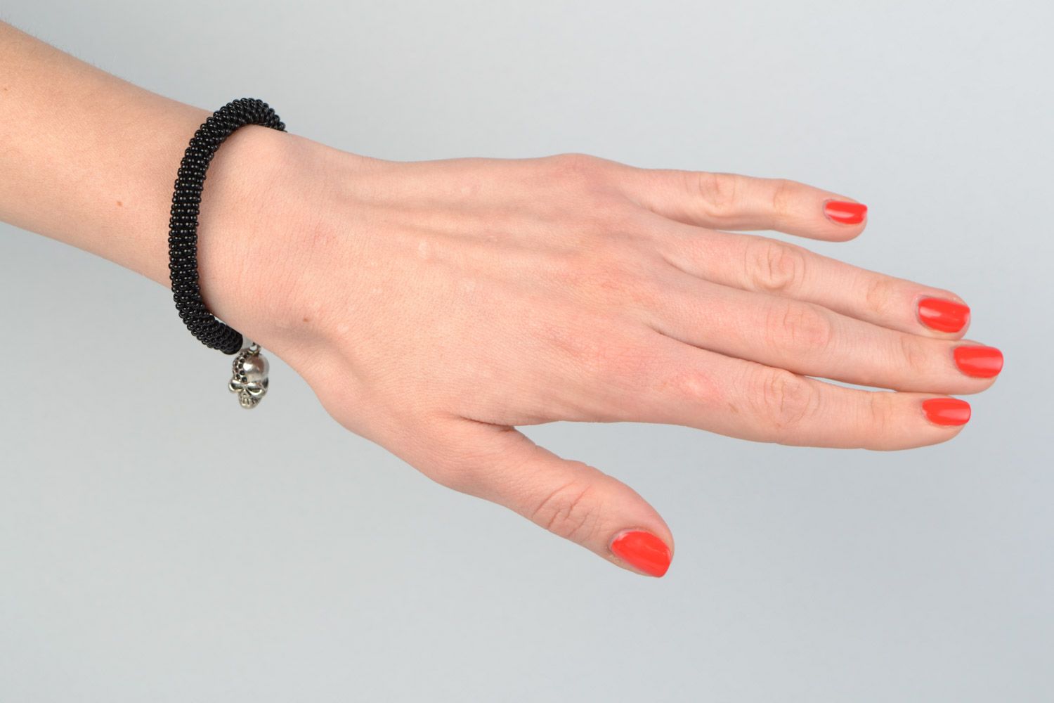 Handmade beaded cord women's wrist bracelet in black color with skull charm photo 1
