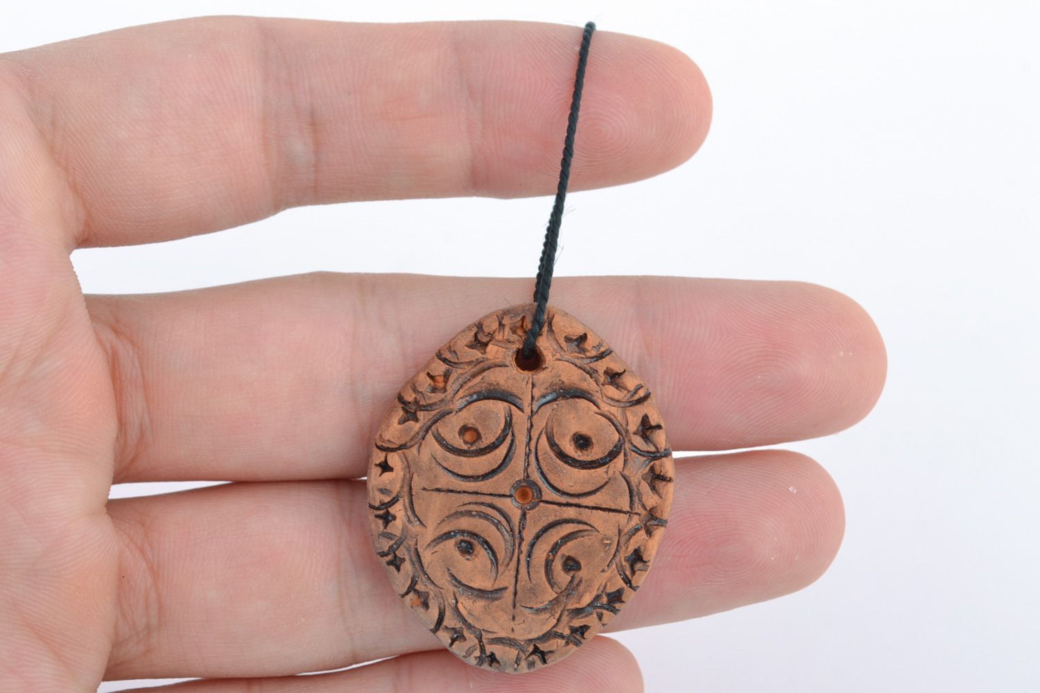 Small handmade ceramic wall hanging with embossed ornament in ethnic style photo 2
