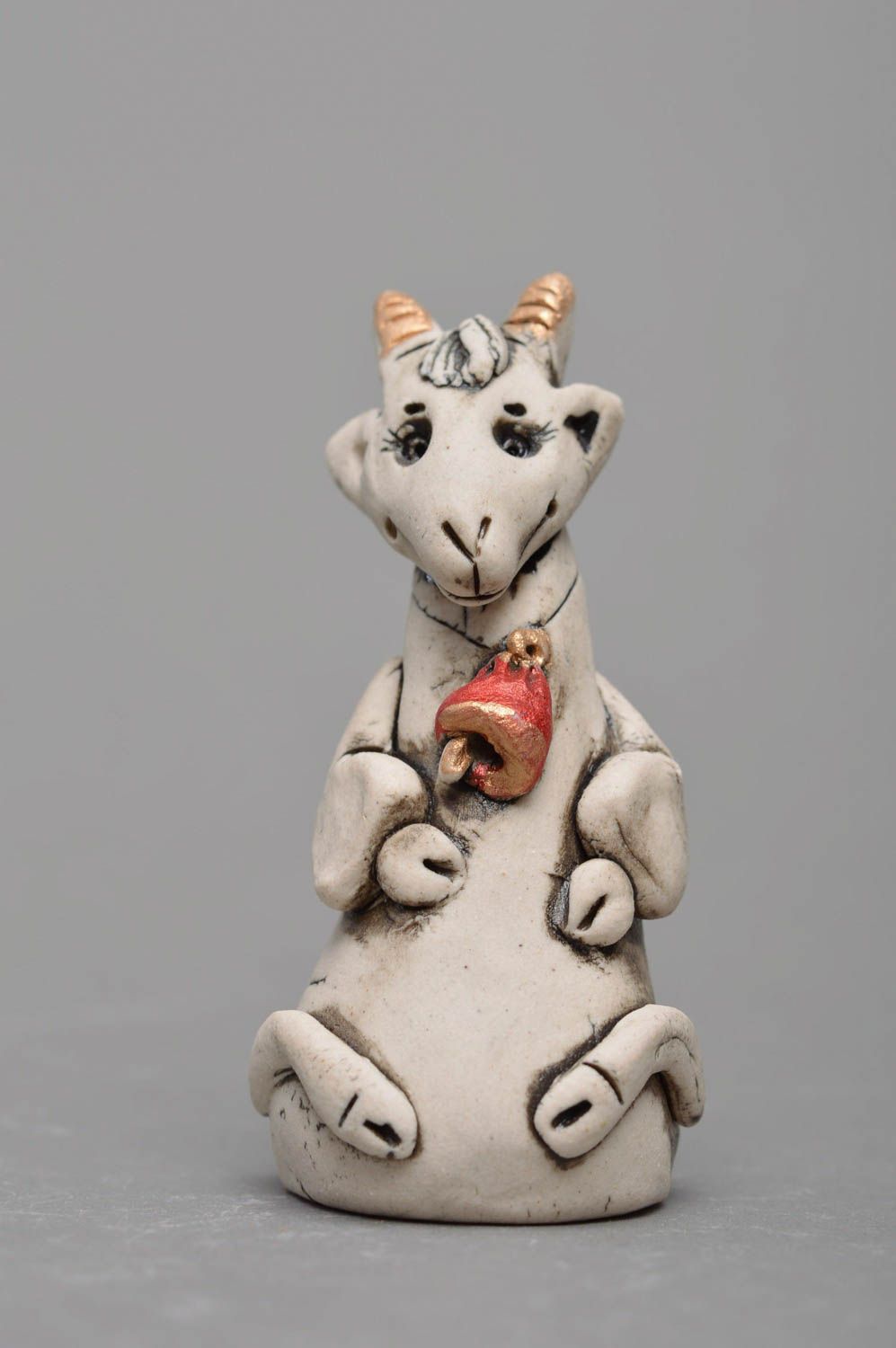 Handmade designer small white glazed porcelain figurine of goat with red bell photo 1