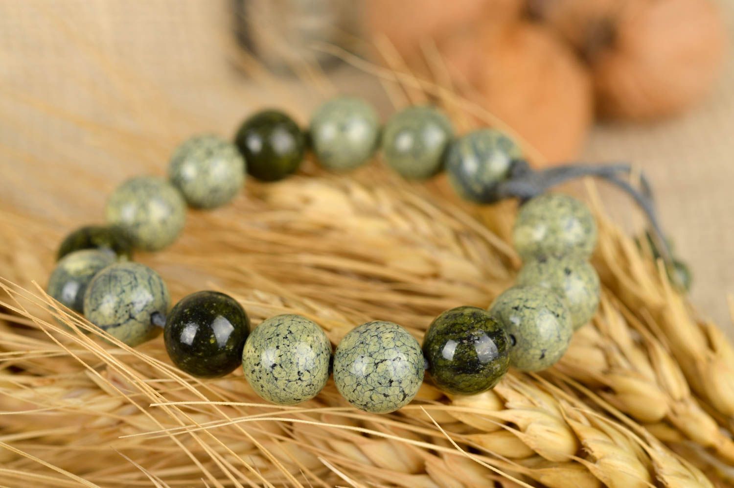 Strand pale green and black beaded bracelet on gray wax cord photo 1