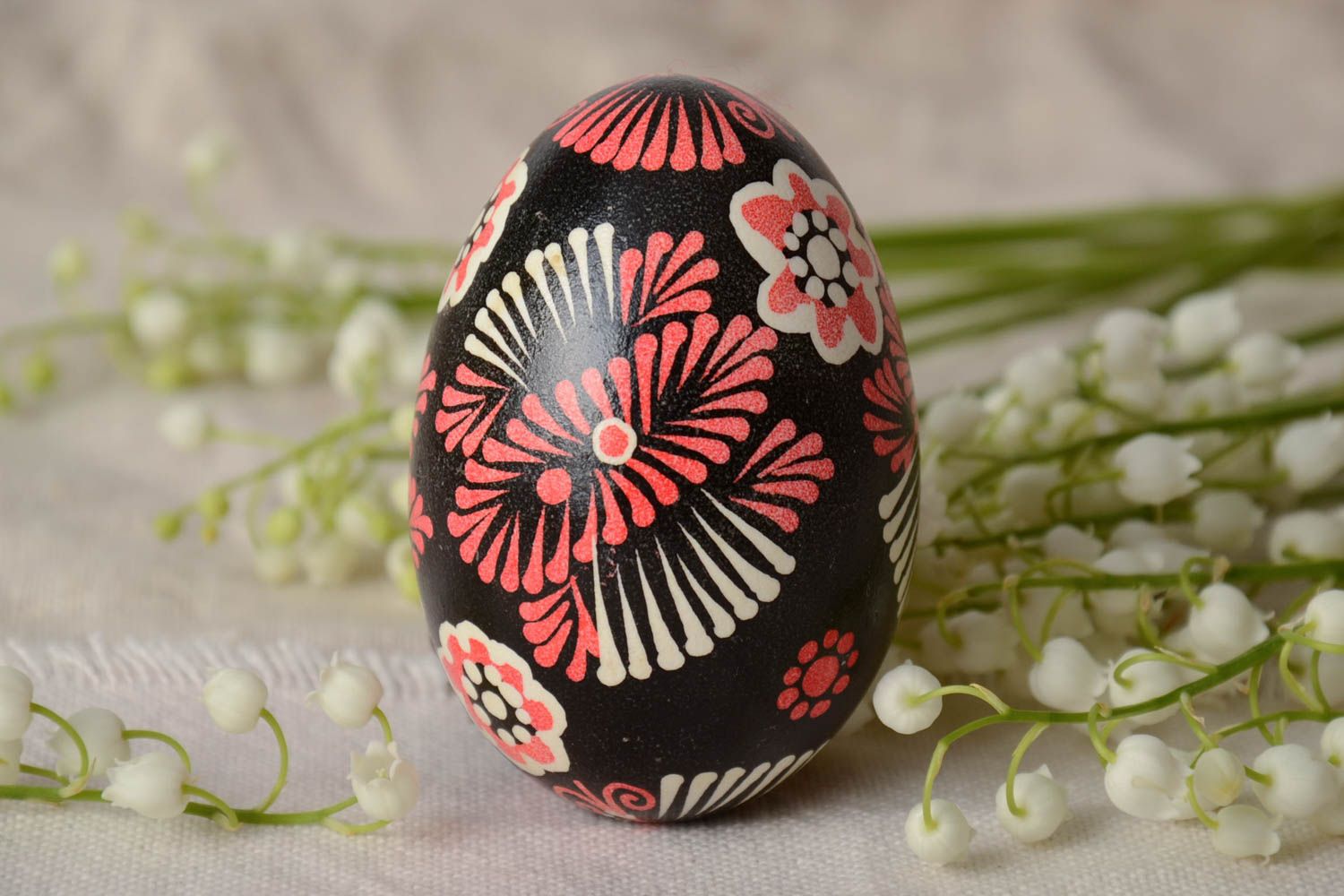 Handmade decorative painted Easter egg with ornament on black background photo 1