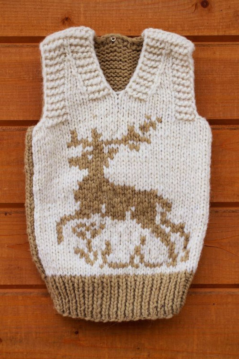 Knitted children's vest with a deer photo 1