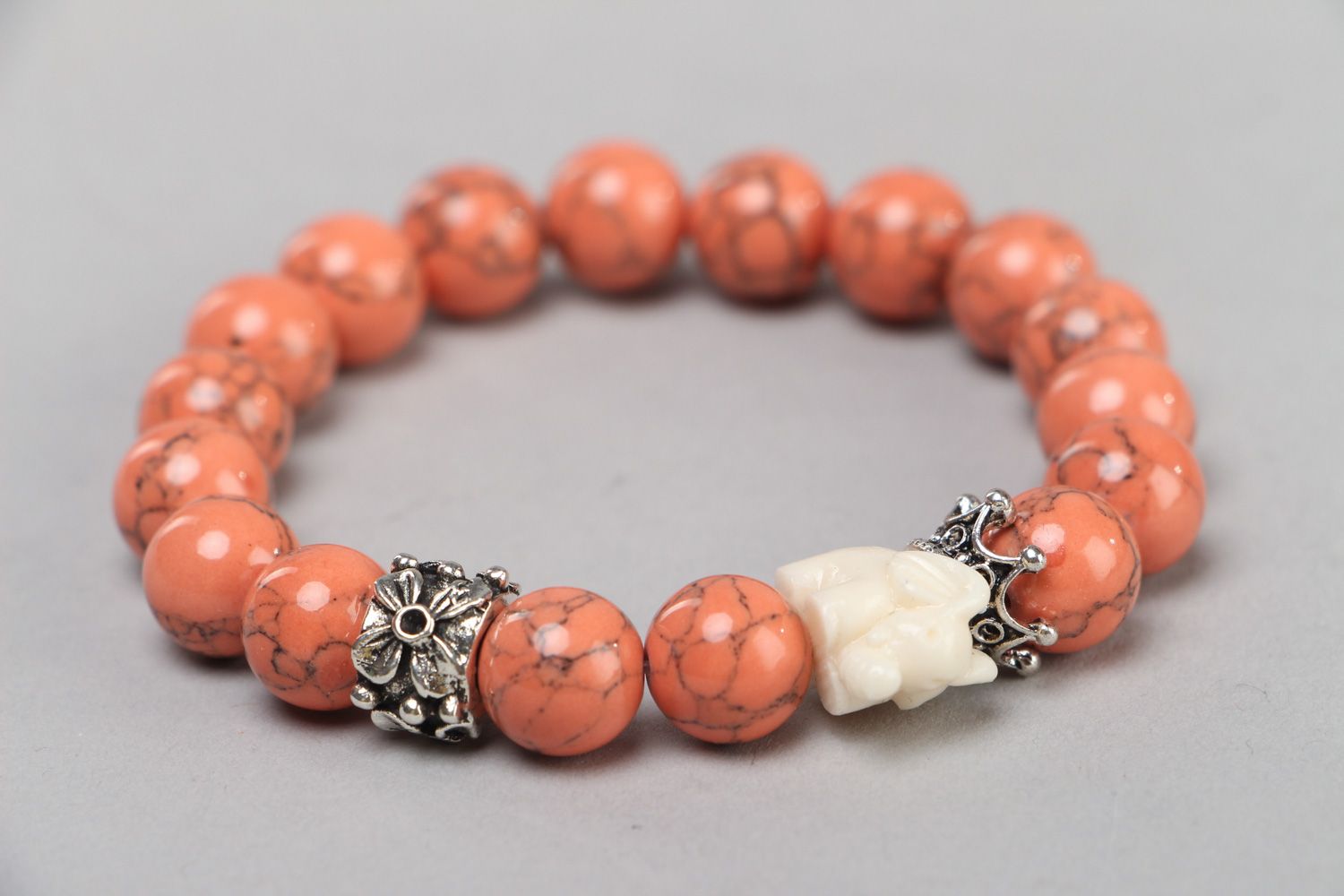 Handmade stretch wrist bracelet with natural coral beads and elephant figurine photo 1