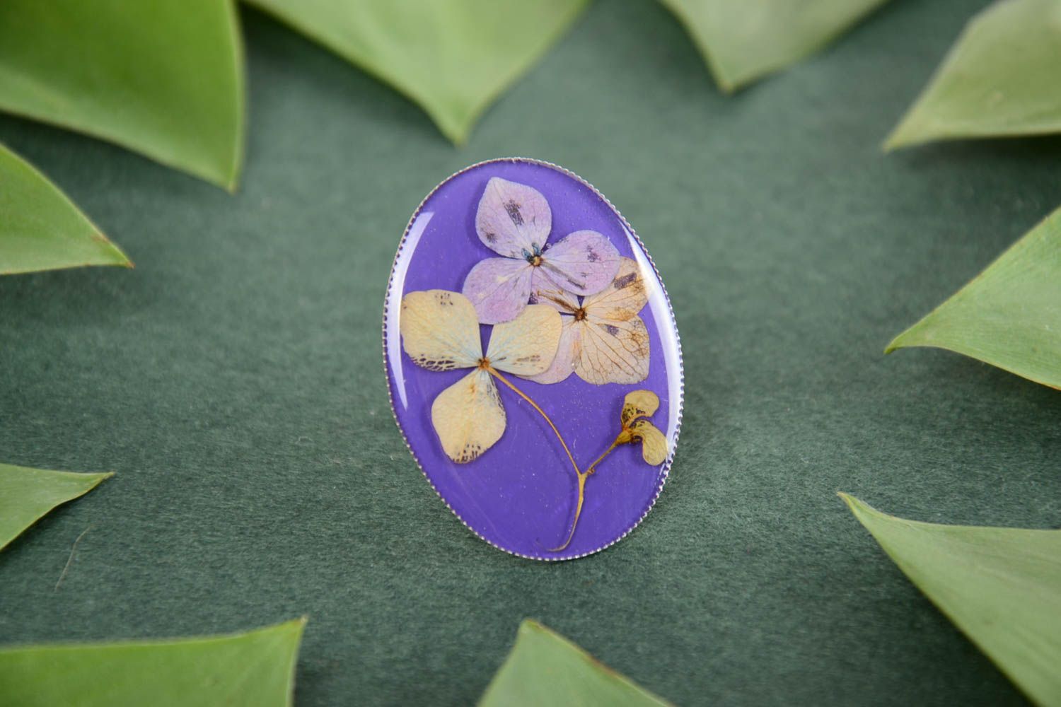 Handmade designer oval ring with dried flowers in epoxy resin on metal basis photo 1