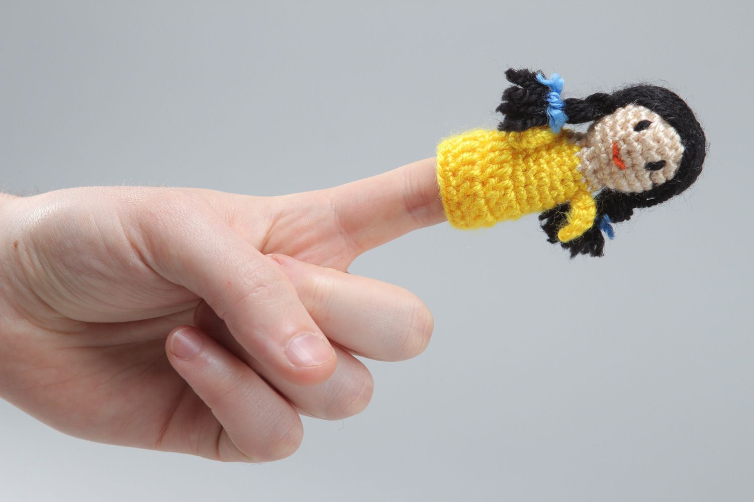Handmade finger puppet crocheted of acrylic threads girl in yellow dress photo 4