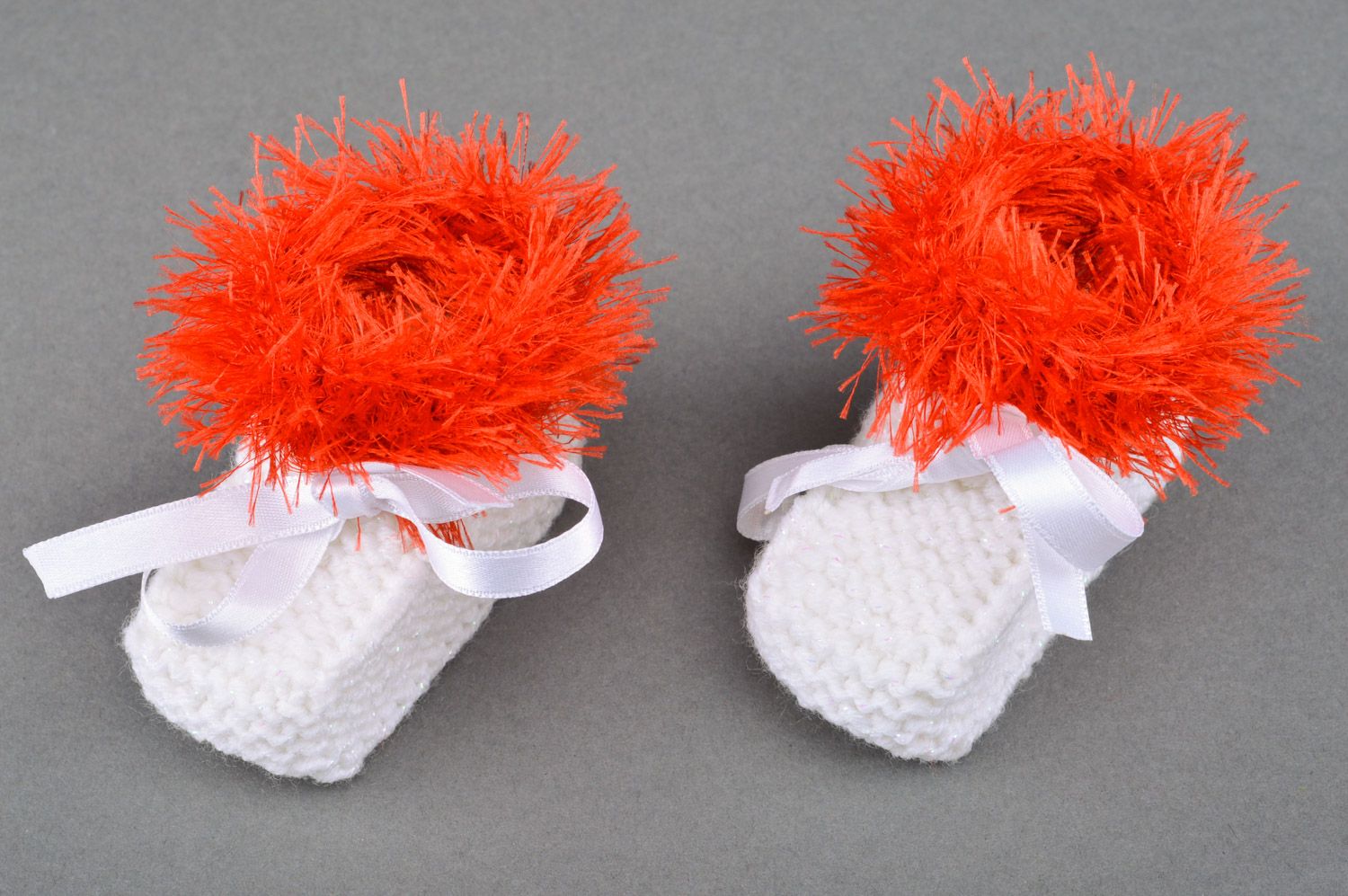 Beautiful handmade knitted baby booties of white color with red edge and satin bow photo 5