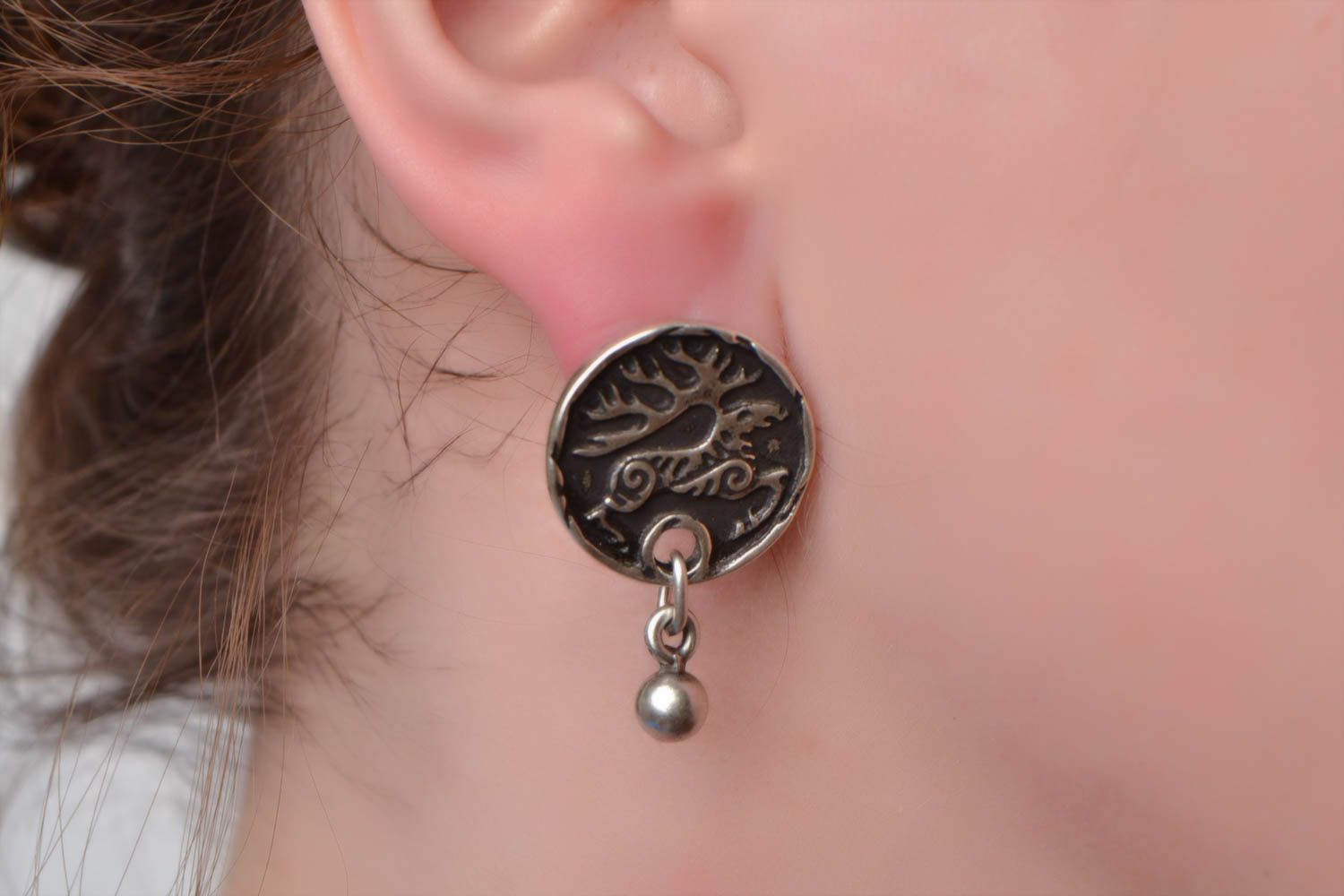 Handmade small round stud earrings cast of hypoallergenic metal with deer image photo 1