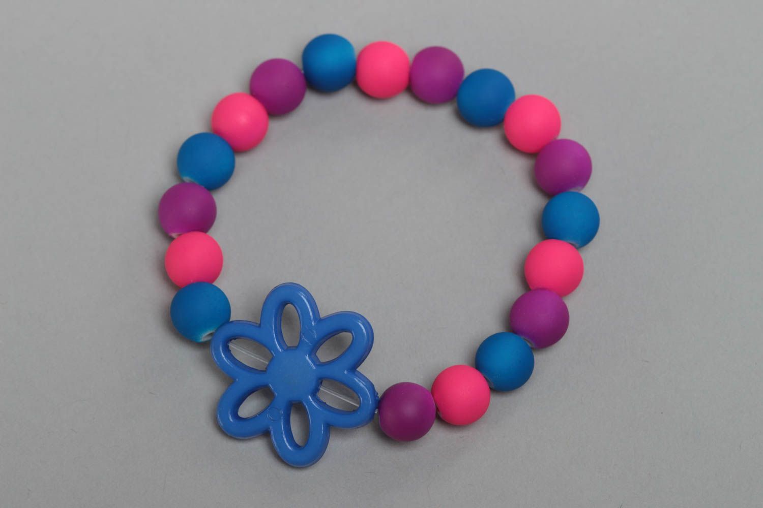 Colorful homemade children's wrist bracelet with plastic beads and flower photo 2