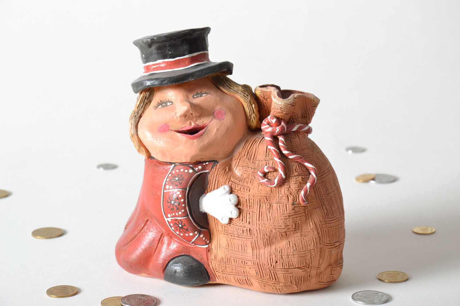 Ceramic money box in the shape of a man with a bag photo 1