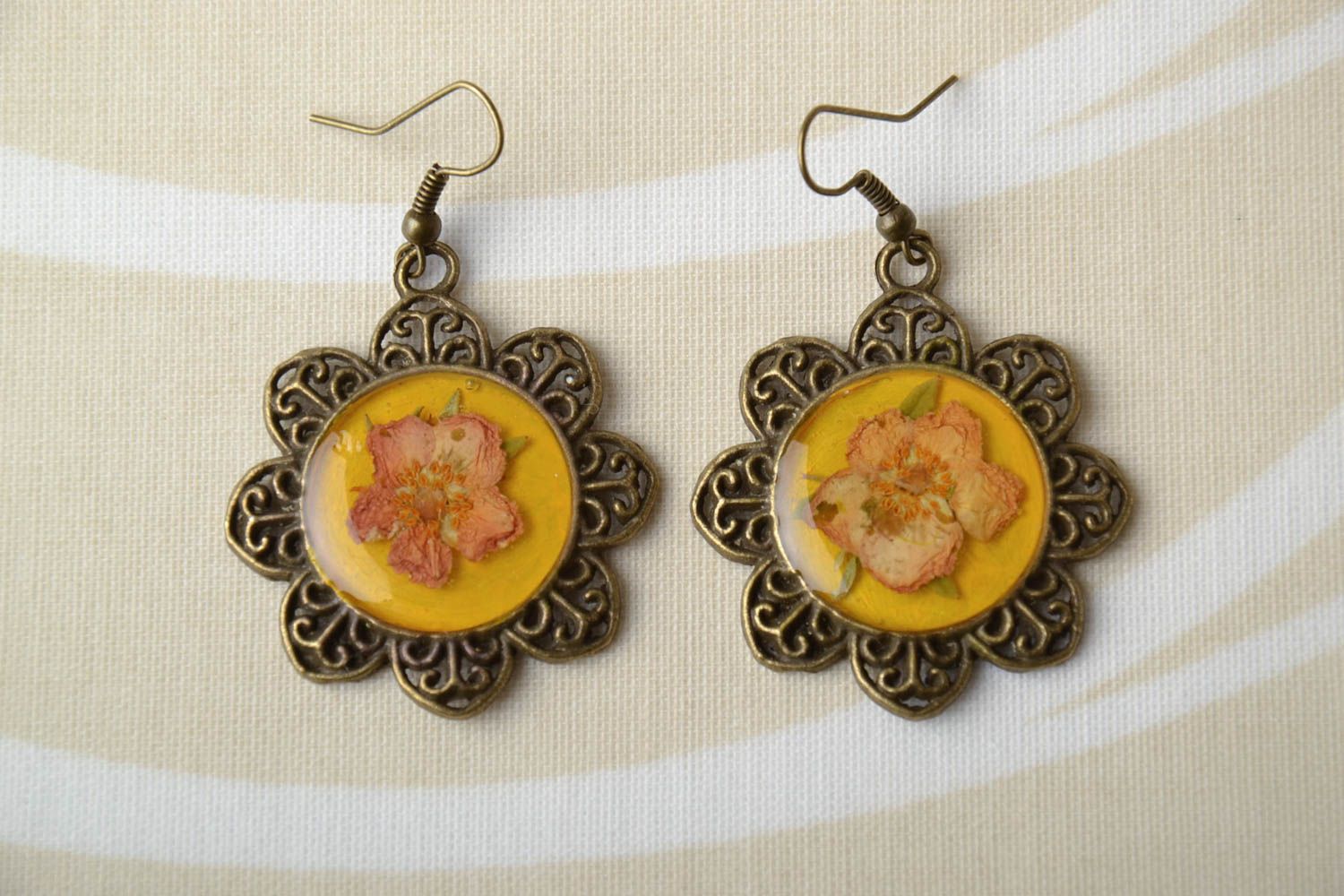 Unusual earrings with natural flowers in epoxy resin photo 1