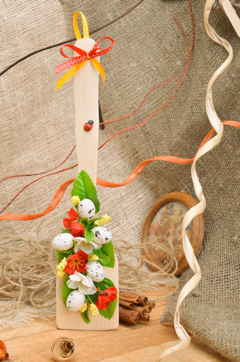 Handmade decorative wooden spatula with flowers and hollow eggs for wall decor photo 1