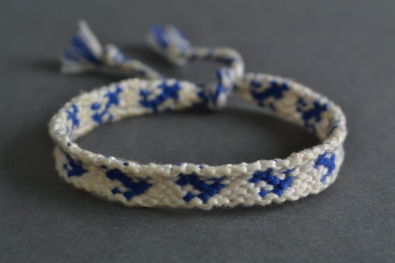 Handmade thin white and blue friendship wrist bracelet woven of threads with tie photo 1
