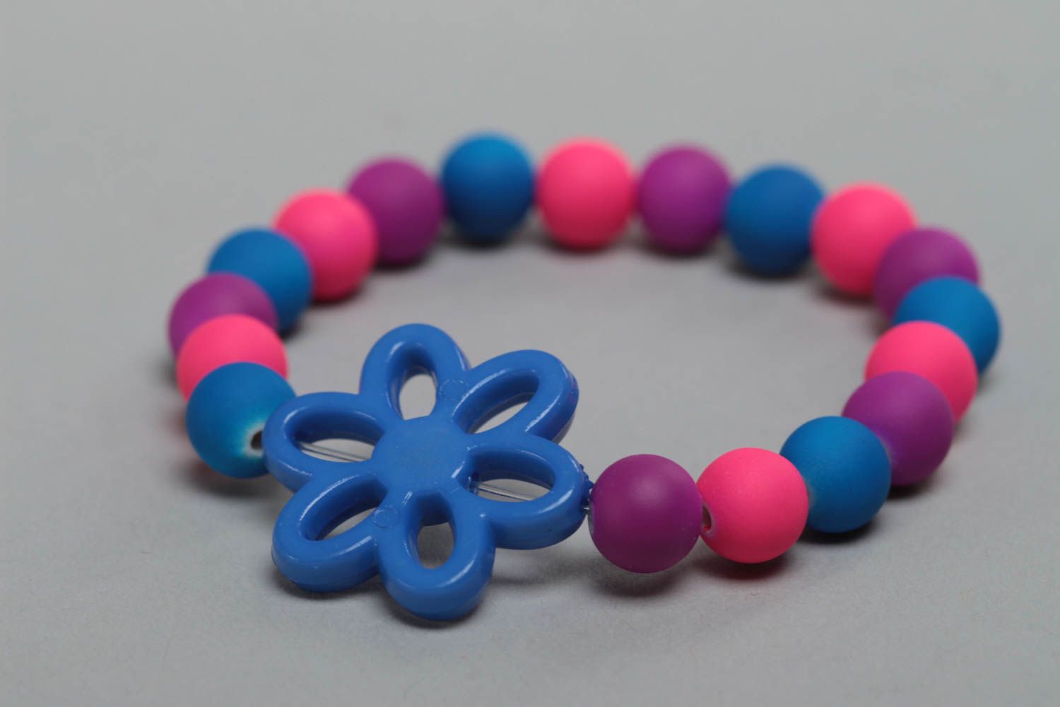Colorful homemade children's wrist bracelet with plastic beads and flower photo 3