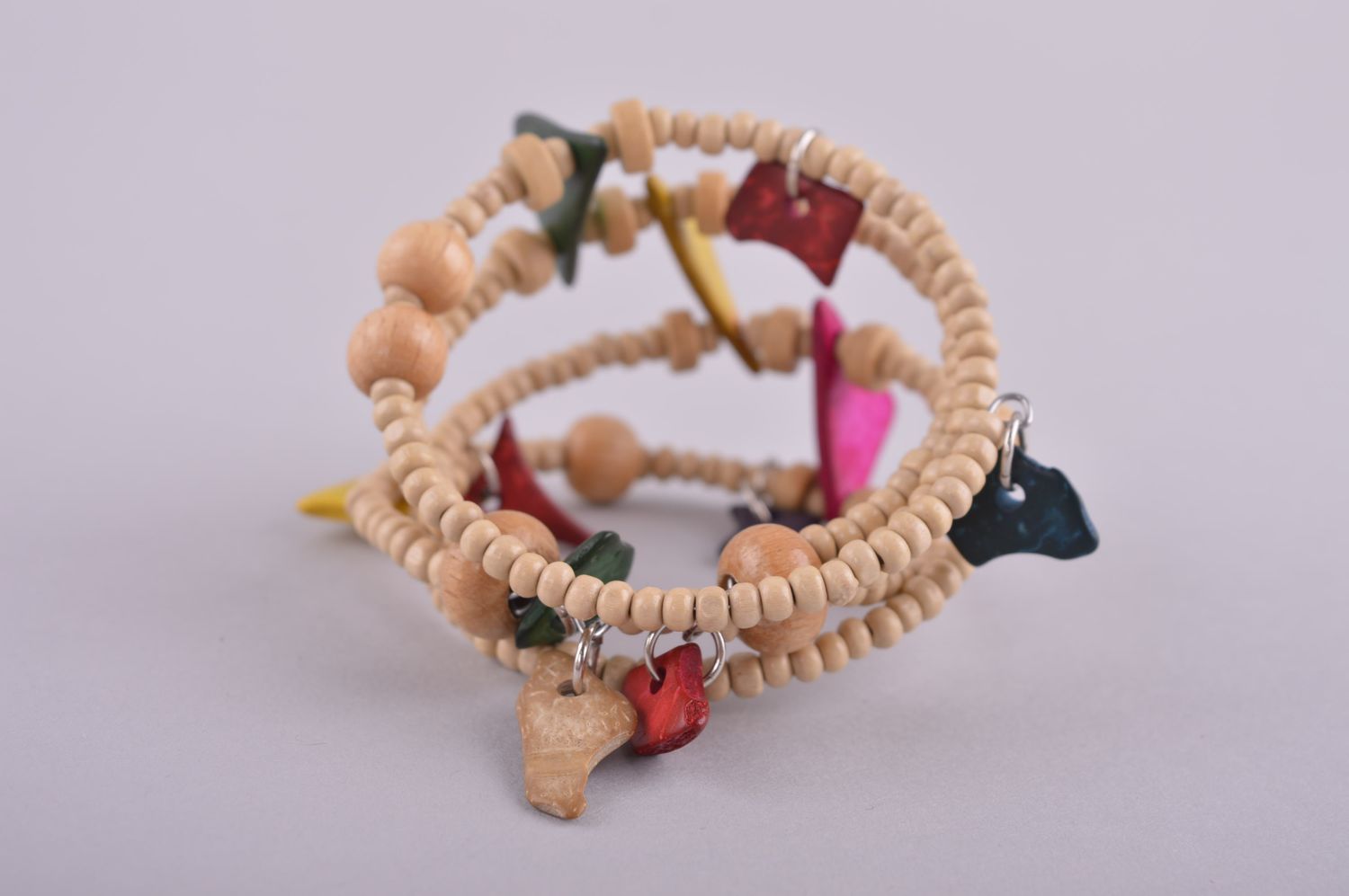 Wooden stretchy four-row beaded bracelet with the ball and geometric shape beads photo 4