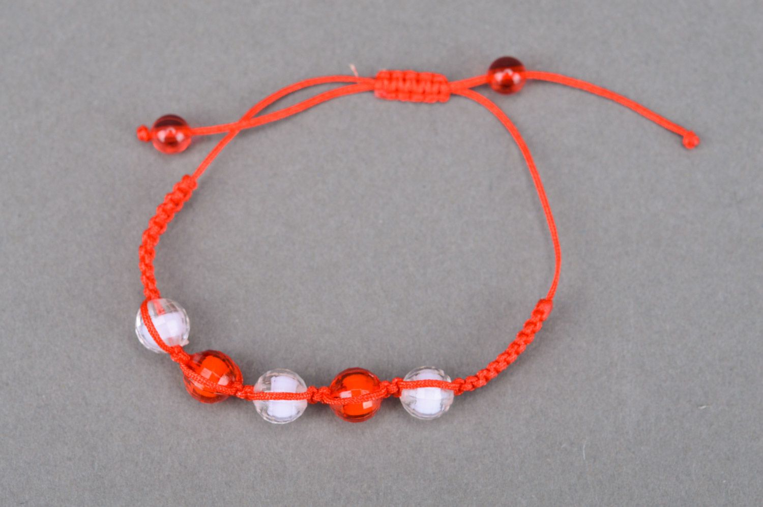 Beautiful bright handmade children's bracelet woven of threads and beads photo 2