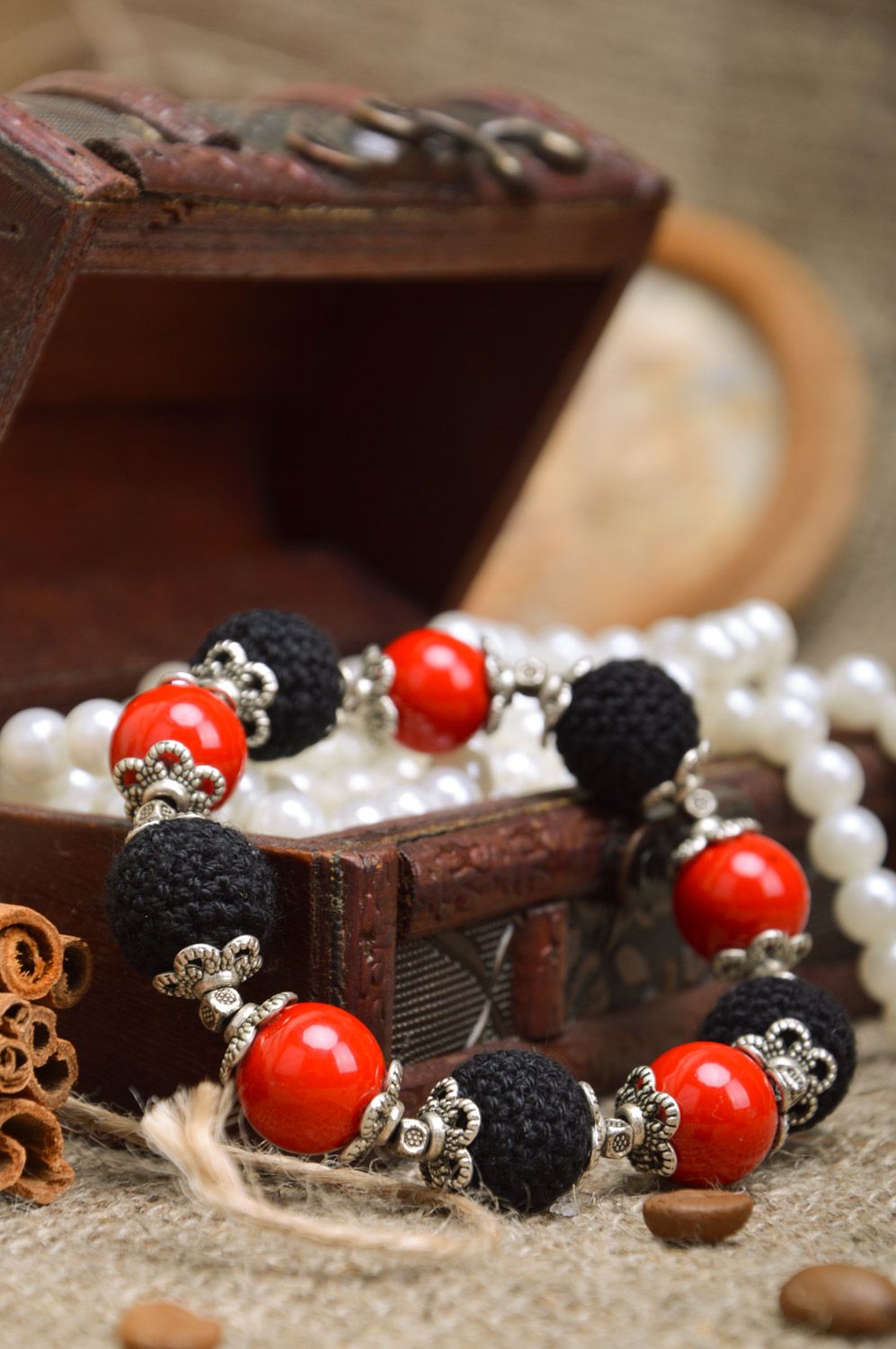 Handmade red and black wrist bracelet with beads crocheted over with threads Passion photo 1