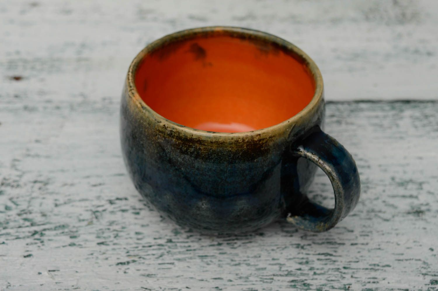 Glazed ceramic handmade coffee cup in deep blue and orange color with handle photo 2