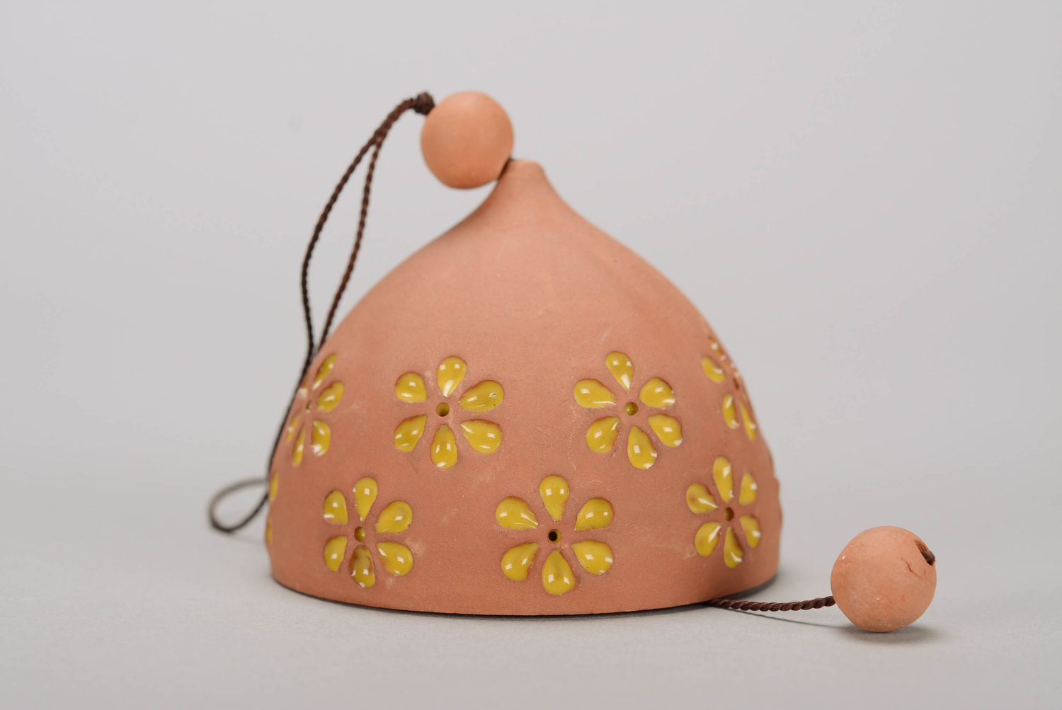 Glazed bell made from red clay photo 1