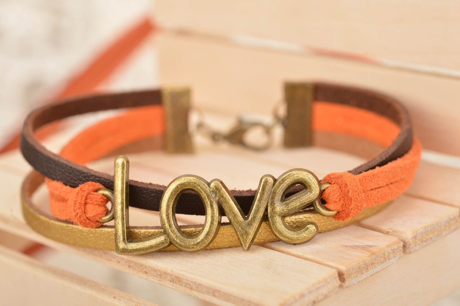 Unusual beautiful orange bracelet woven of suede cords with inserts Love photo 1
