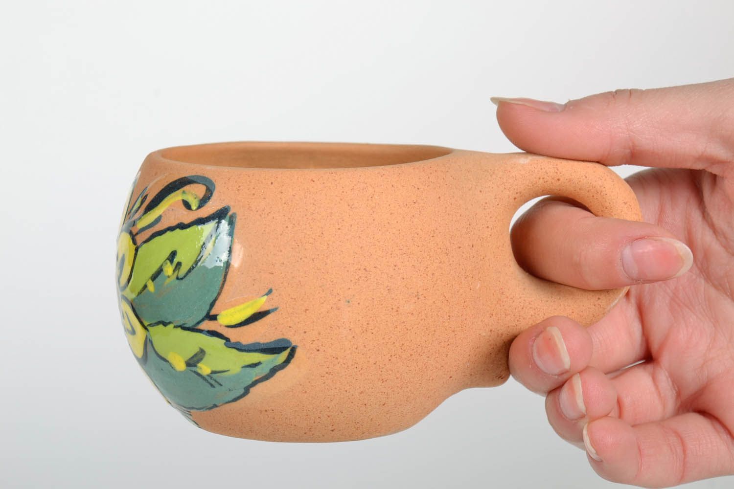 Natural clay rustic cup with handle and lime and yellow color floral pattern photo 2