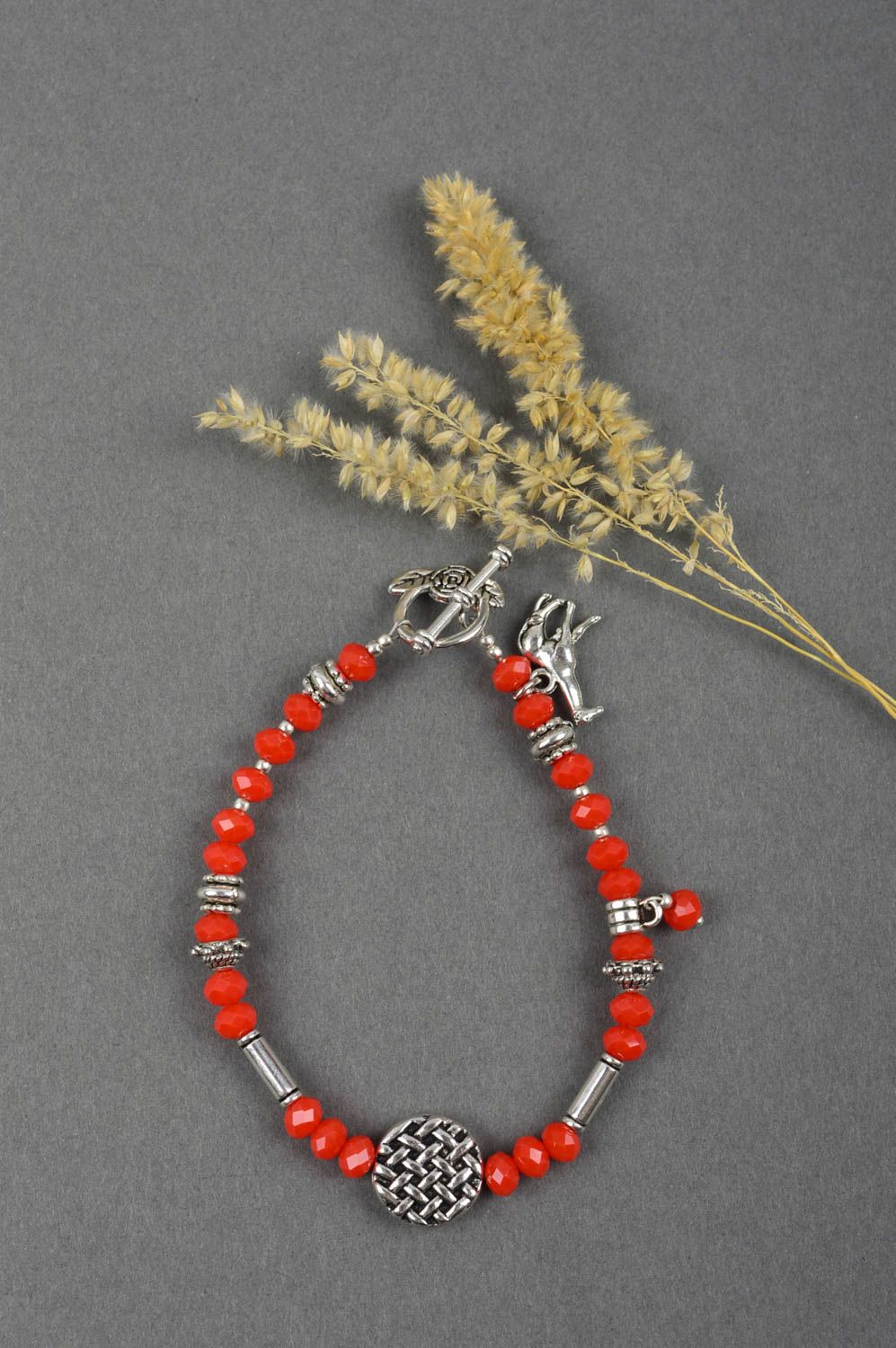 Handmade red beads bracelet with metal giraffe charm photo 1