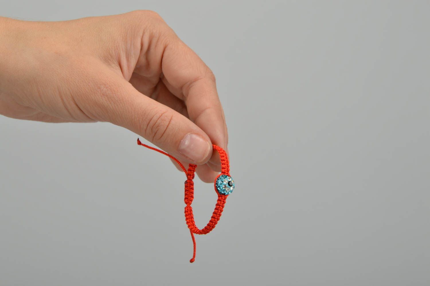 Dünnes handmade geflochtenes Armband rot aus gewachster Schnur mit Glasperle foto 2