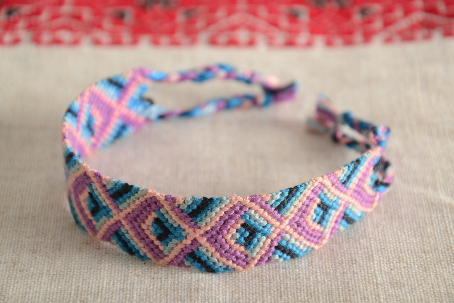 Handmade friendship wrist bracelet woven of threads with bright ornament and ties photo 1