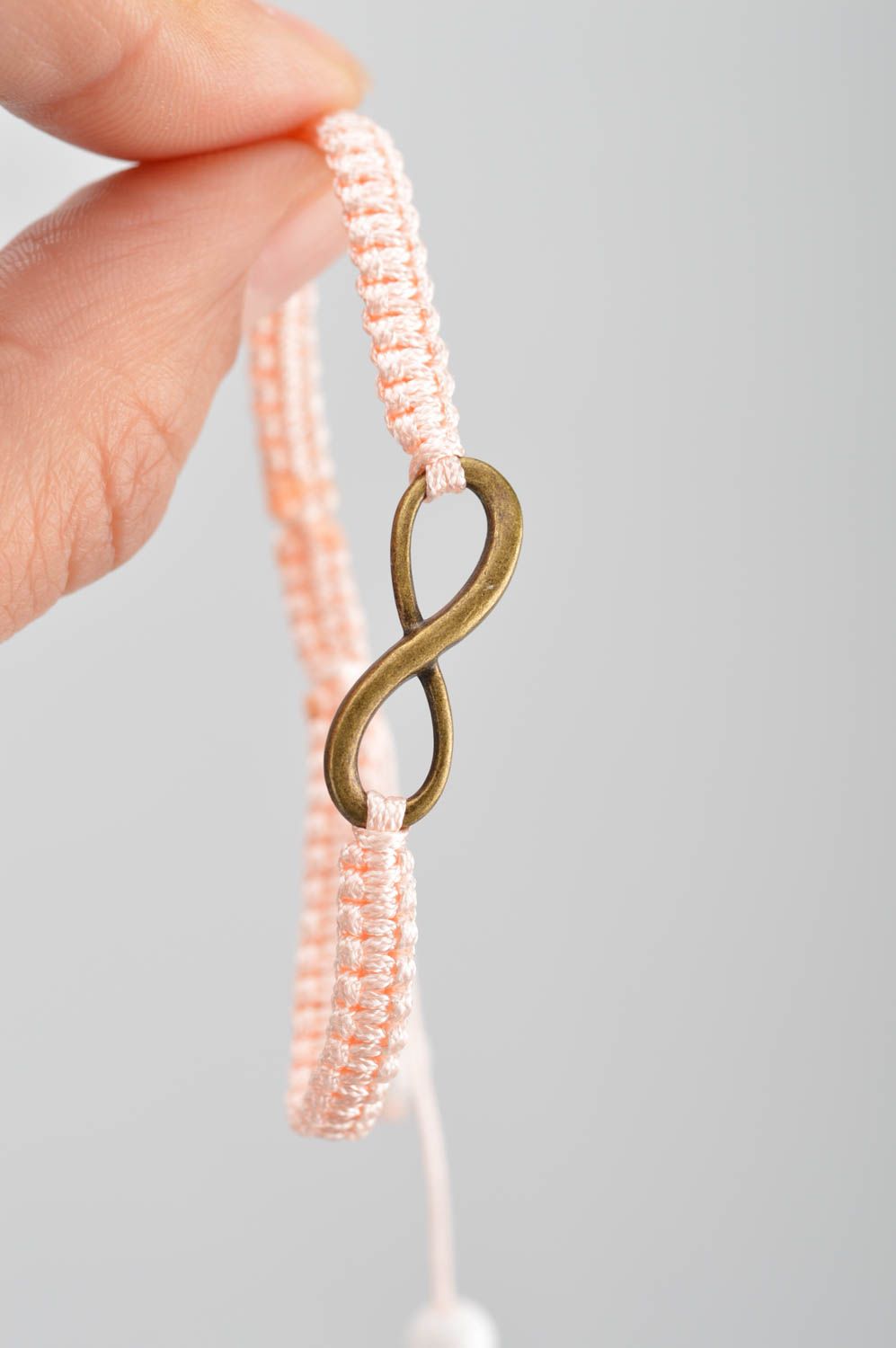 Handmade stylish thin pink woven wrist bracelet made of silk with insert photo 3