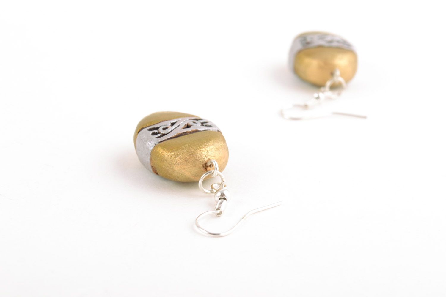 Unusual handmade ceramic dangling earrings of oval shape and golden color photo 3