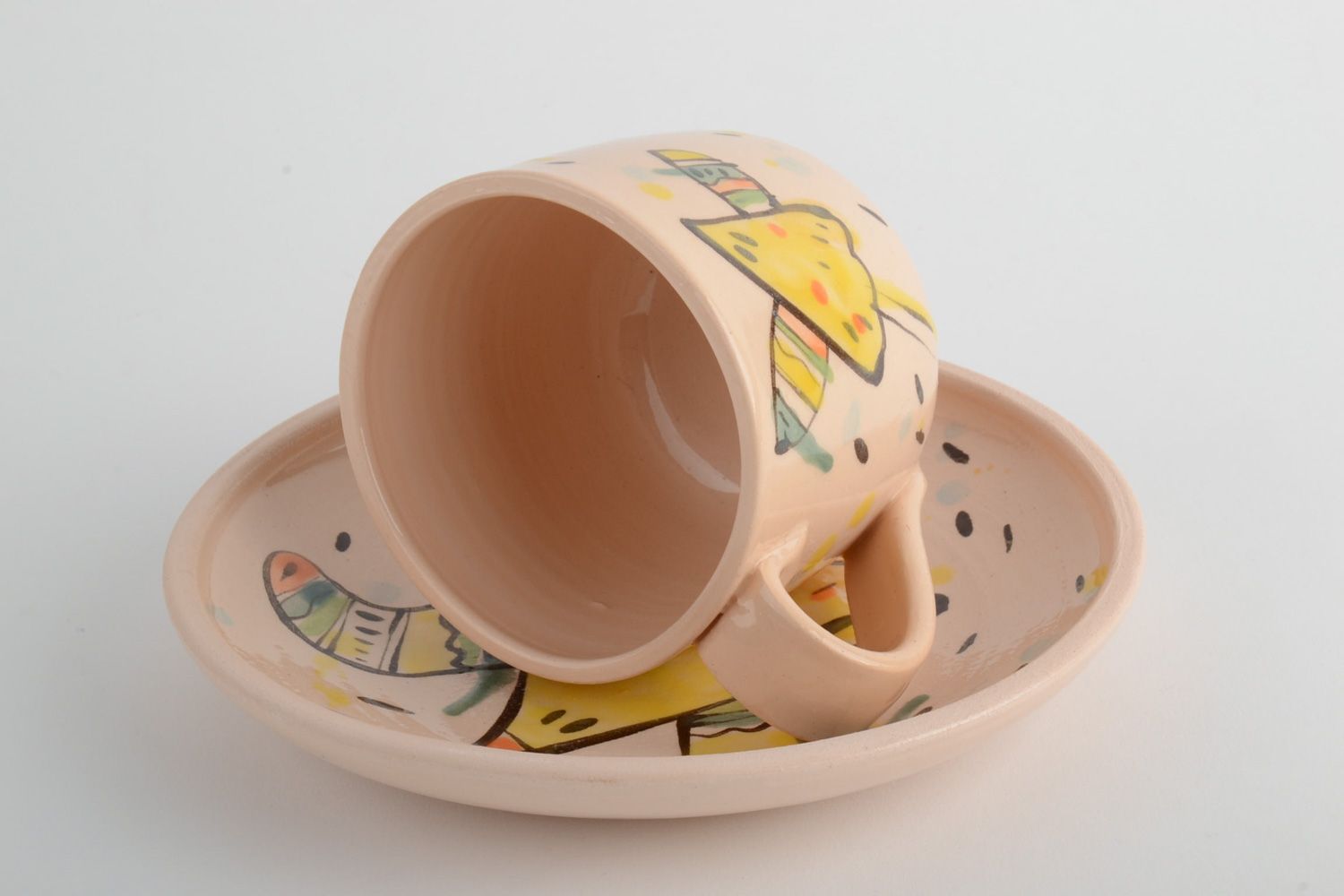 Handmade ceramic kids' tea set of a cup and plate in beige color with a funny pattern photo 4