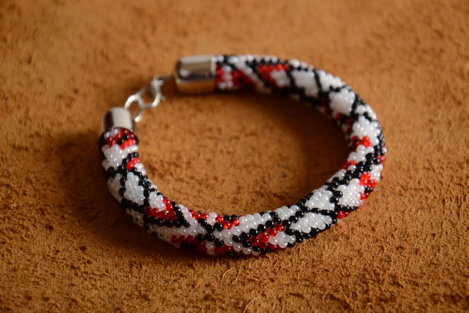 Handmade black, white, and red beaded colorful cord bracelet in ethnic style for women photo 1