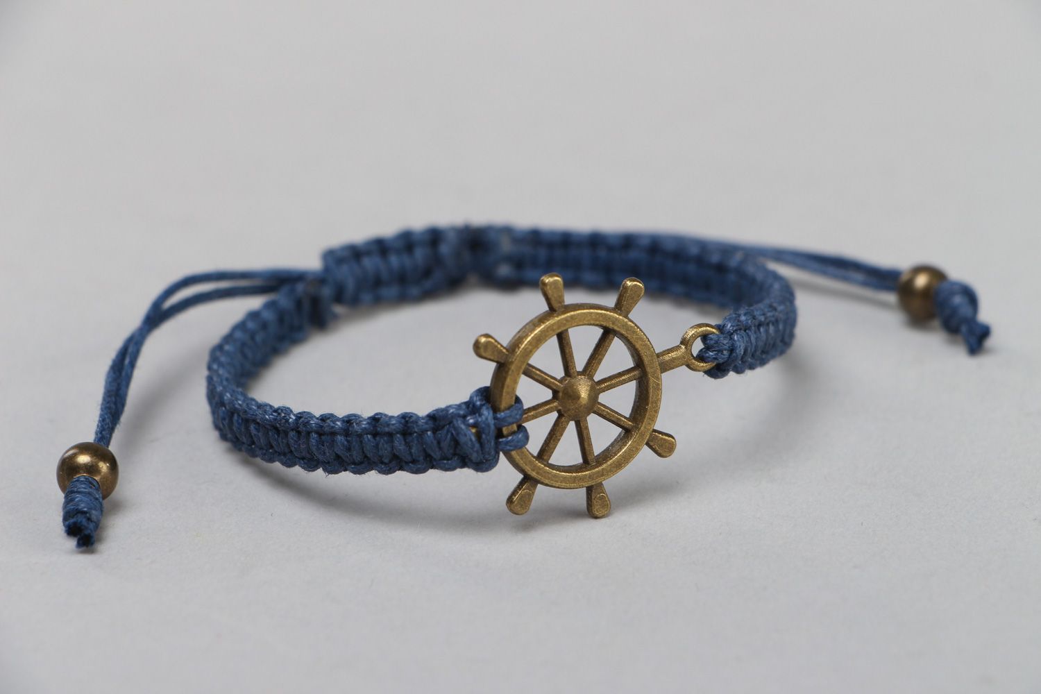 Handmade wrist bracelet woven of blue waxed cord with metal wheel unisex  photo 1