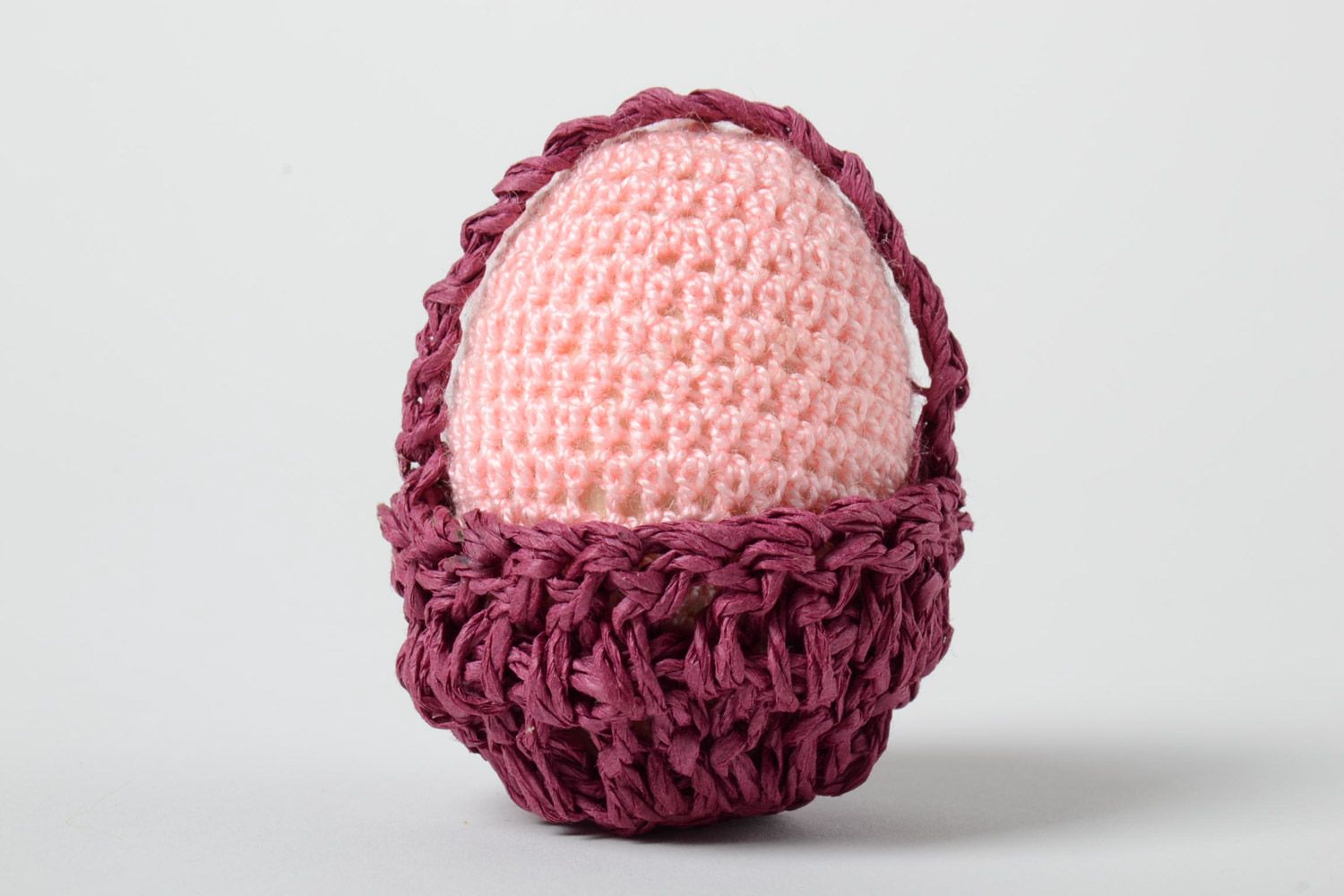 Handmade decorative crochet Easter egg of pink color in basket photo 2