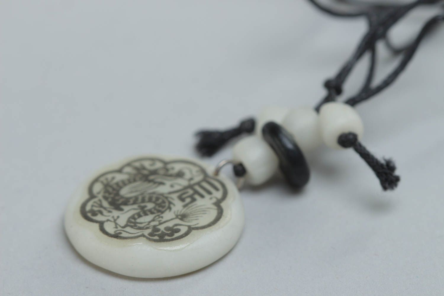 Handmade designer round pendant made of polymer clay with ethnic pattern on cord photo 3