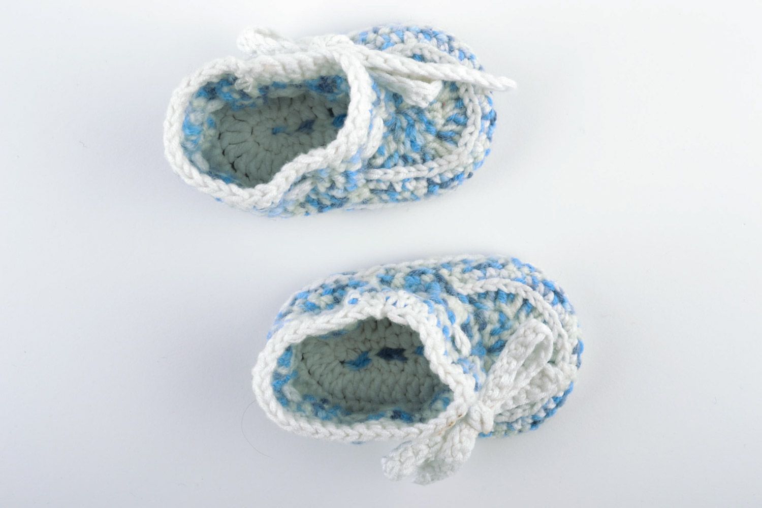 Beautiful handmade knitted woolen baby booties of blue and white colors photo 2