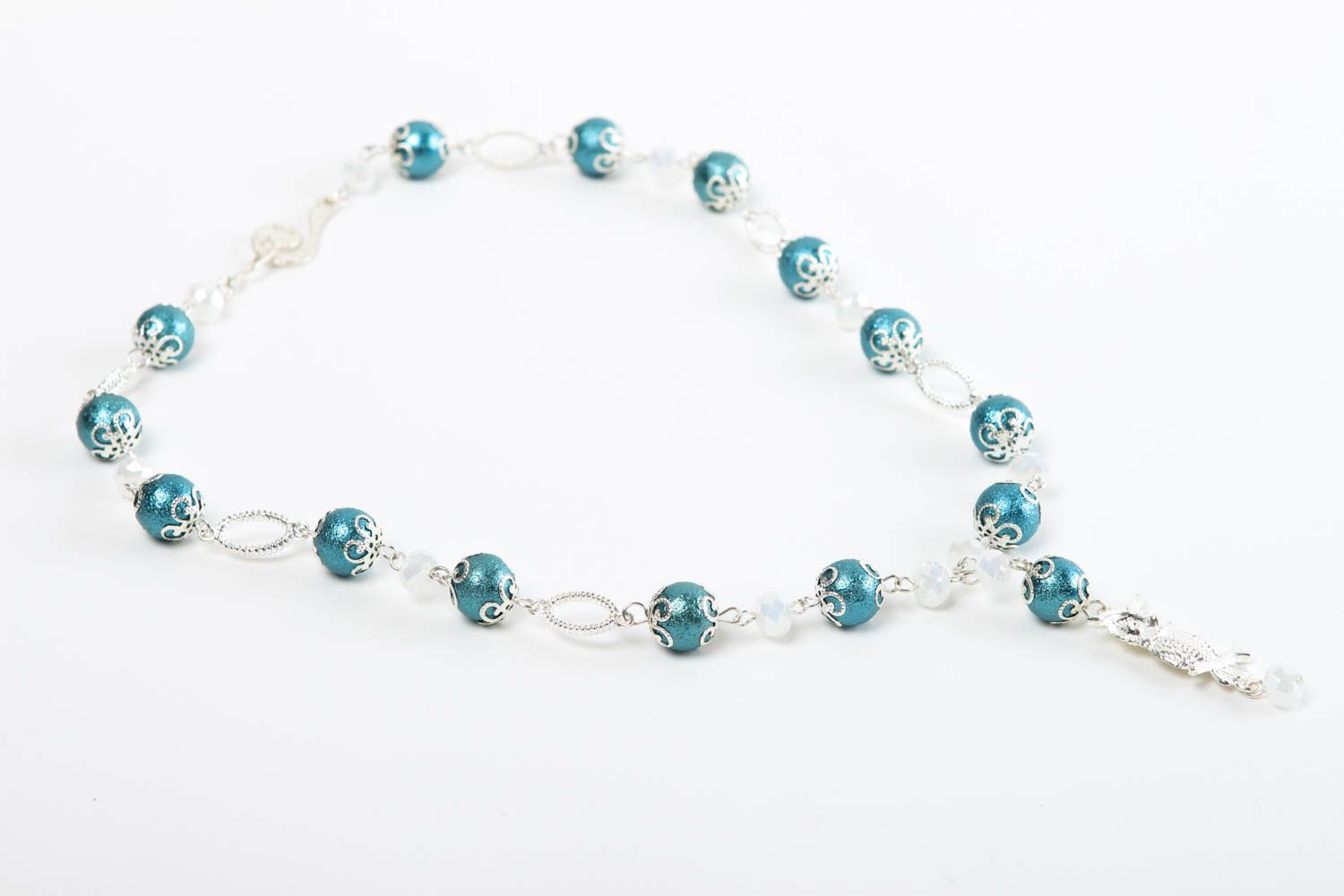 The handmade light beaded bracelet on silver string with blue beads photo 2