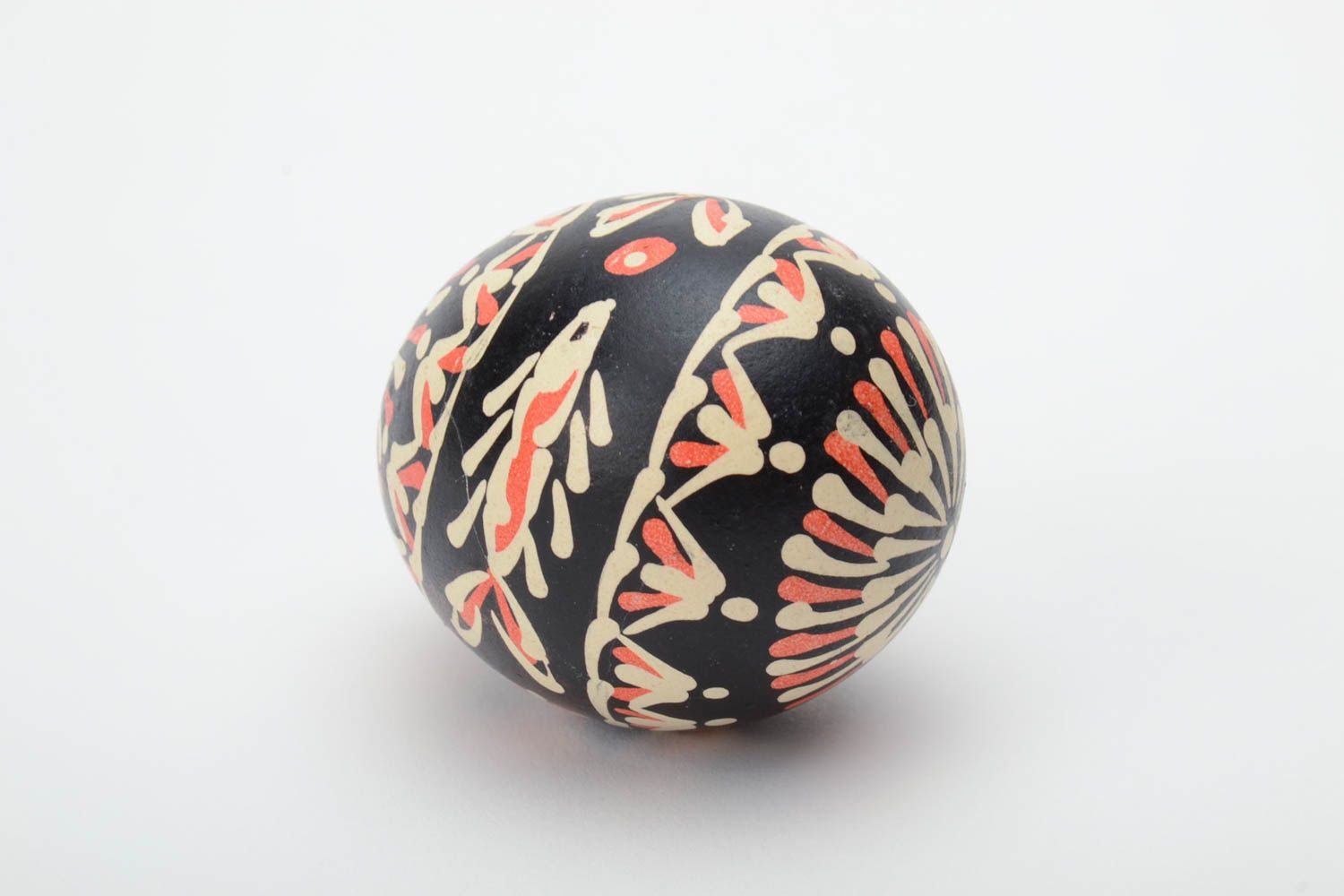 Handmade painted Easter egg of black color with patterns waxing technique photo 4