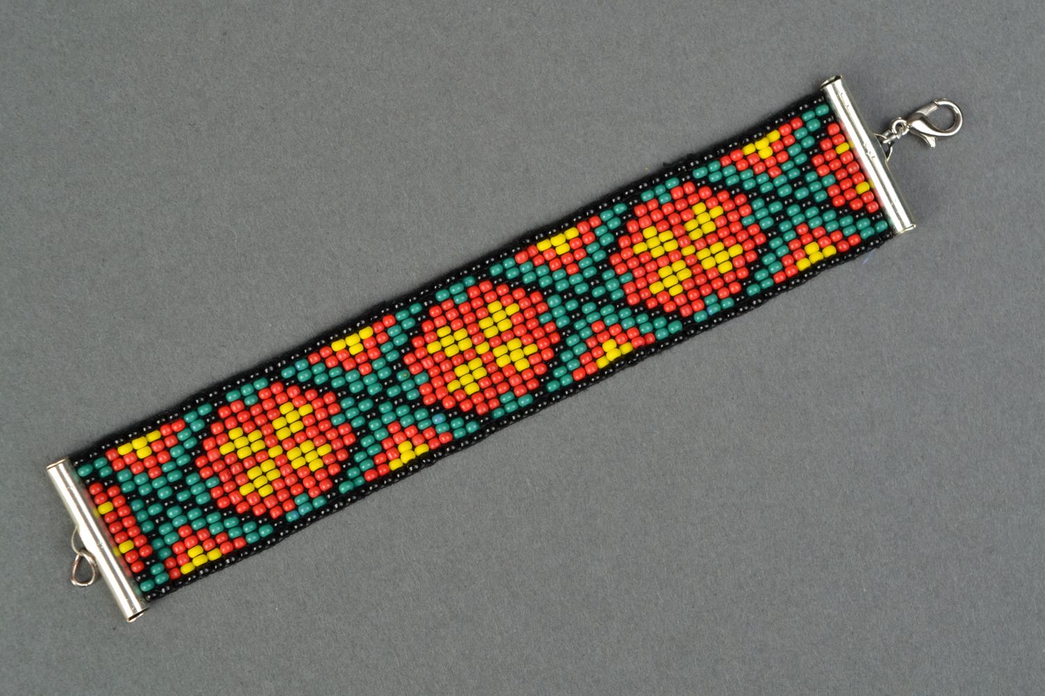 Wide handmade beaded bracelet in ethnic style with ornament in black, orange, red colors photo 1