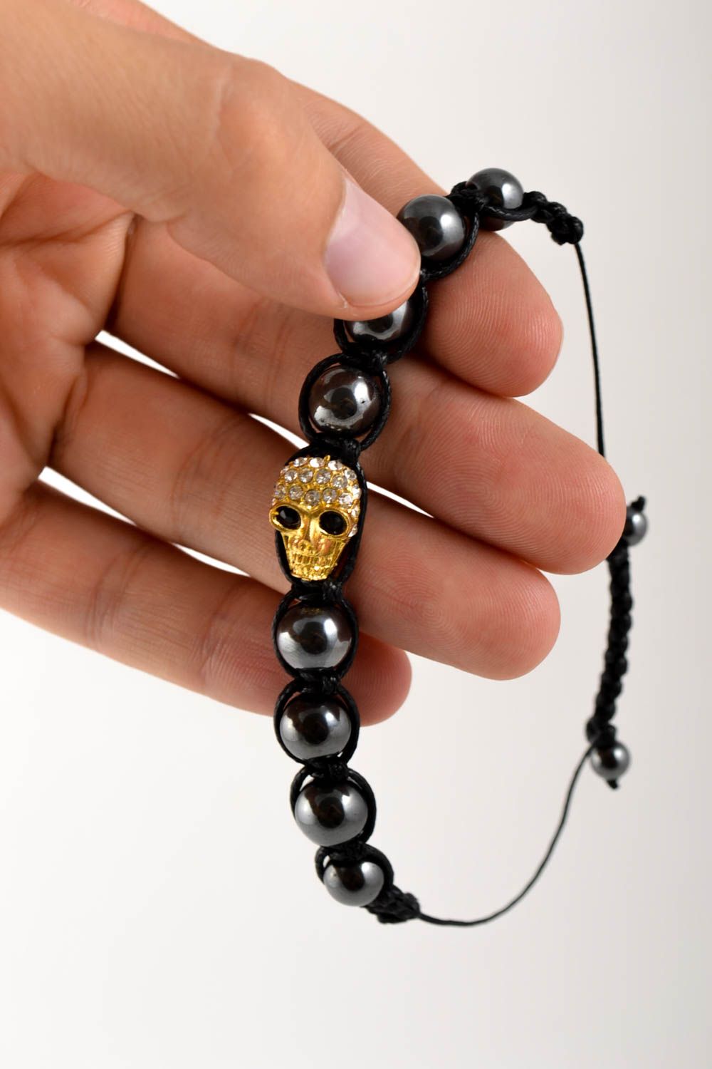 Strand black beads on black cord unisex bracelet with scull centerpiece photo 1