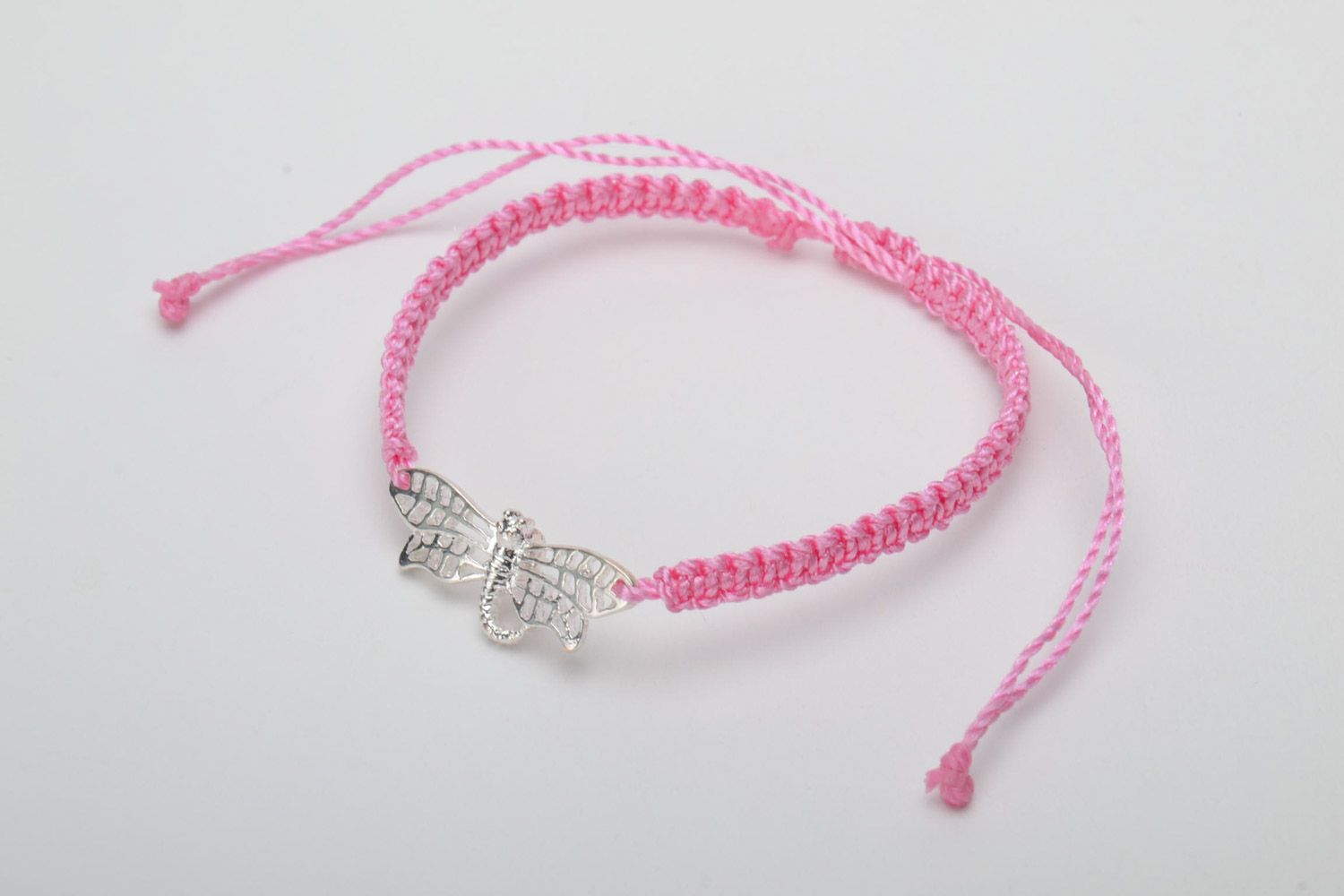 Handmade pink women's woven capron thread bracelet with metal charm in the shape of butterfly photo 3