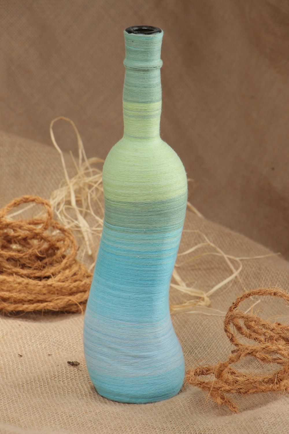 Handmade decorative glass bottle woven over with cotton threads 700 ml photo 1