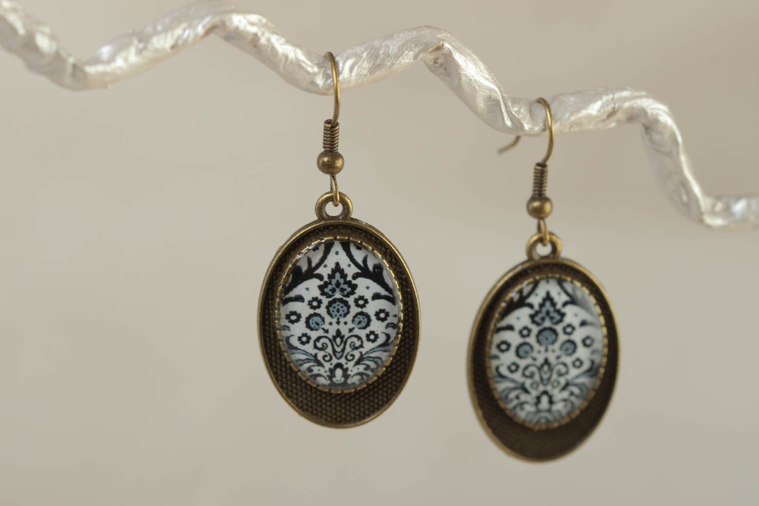 Handmade vintage metal earrings of oval shape with patterns coated with glaze photo 1