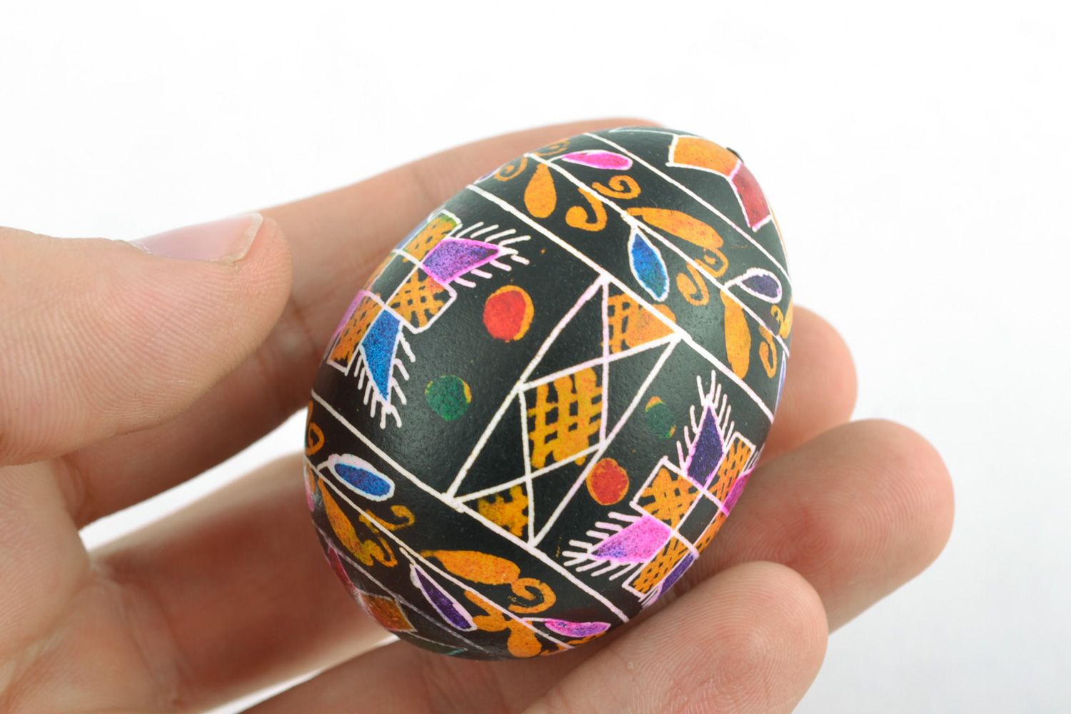 Decorative Easter egg with wax painting of black color with traditional patterns photo 2