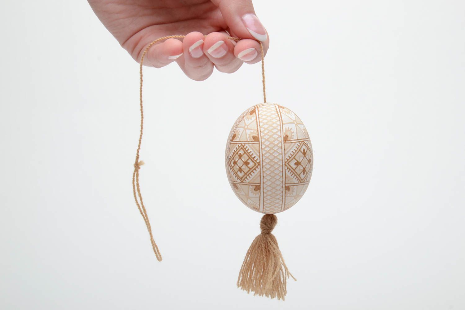 Handmade decorative light beige painted egg with geometric ornaments and tassel photo 5