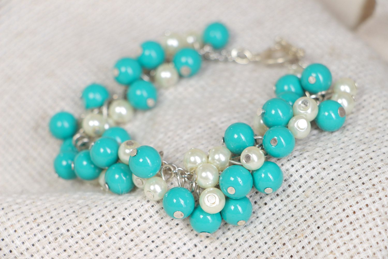 Handmade bright stylish beaded wrist bracelet with charms of turquoise and white colors photo 1