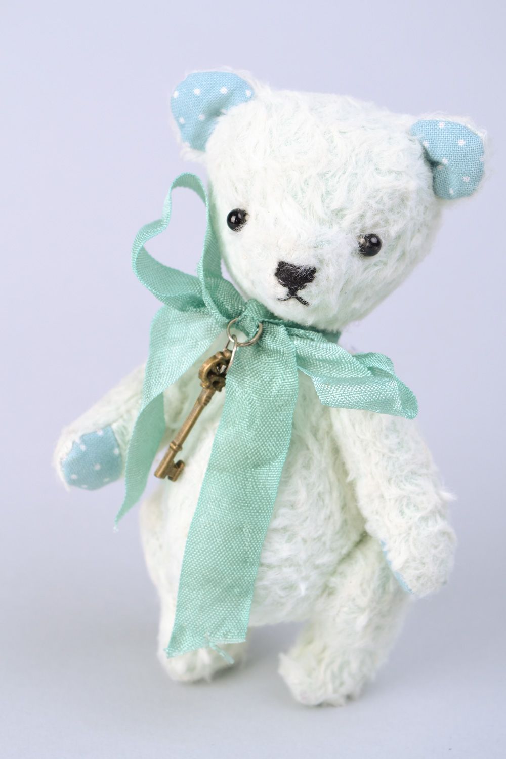 Handmade designer soft toy bear in light color palette with bow and key charm photo 4