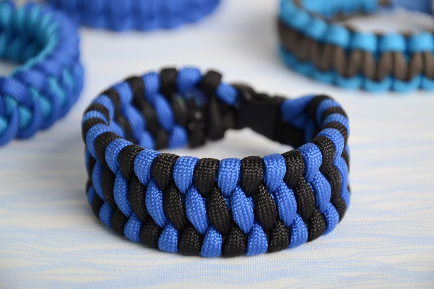 Black and blue handmade wide woven wrist bracelet with plastic fastener photo 1