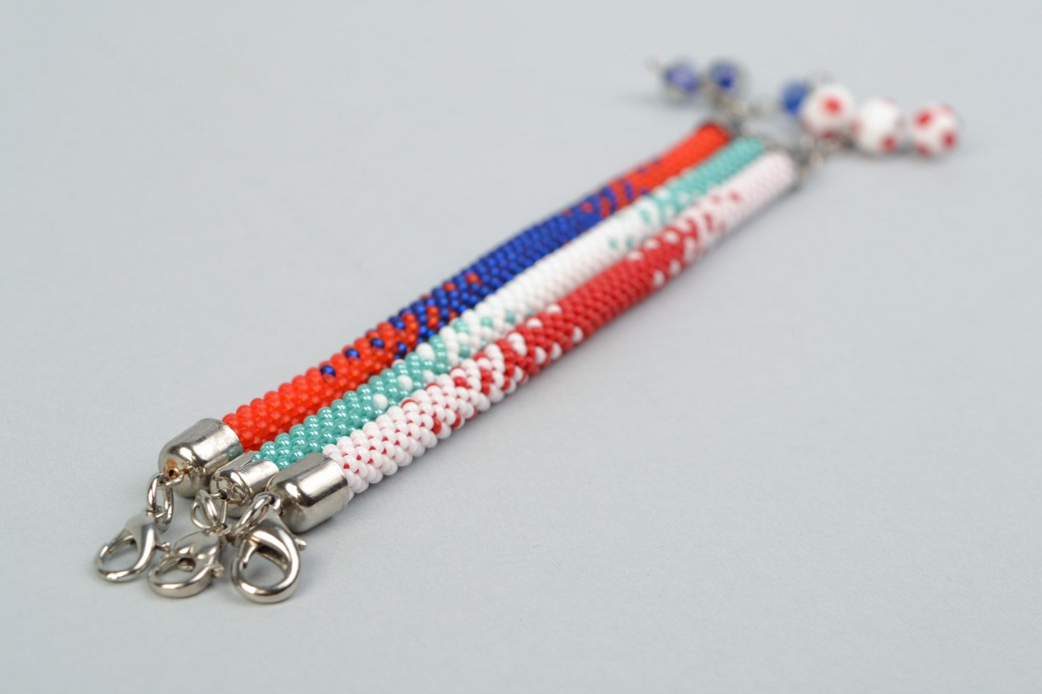 Set of 3 handmade beaded cord bracelets in combinations of white red and blue photo 4